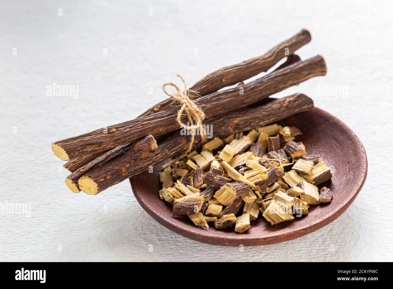 Licorice medicinal plant root, on white background Glycyrrhiza glabra
