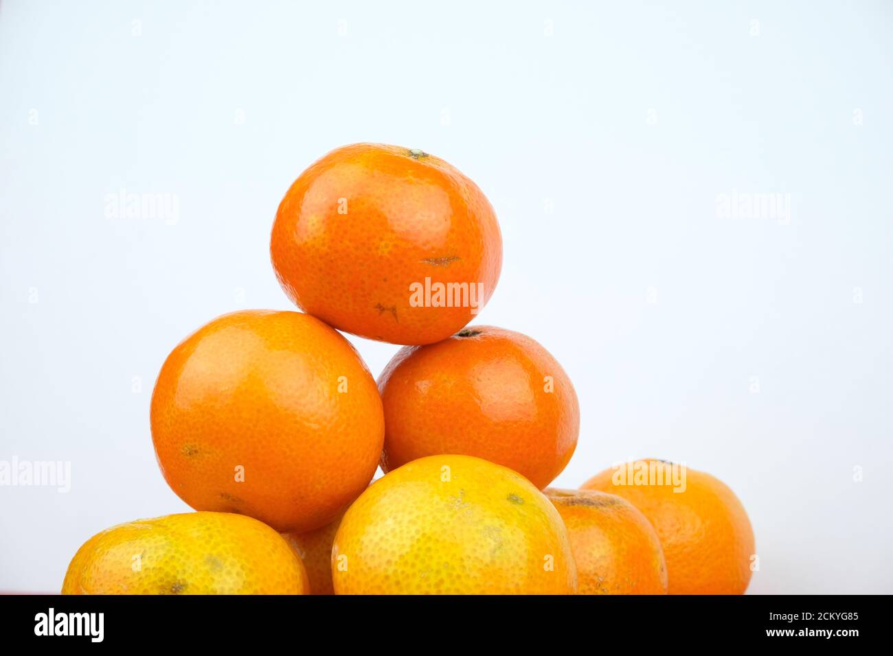 Arranged pile of ripe orange clementines isolated on a white background Stock Photo