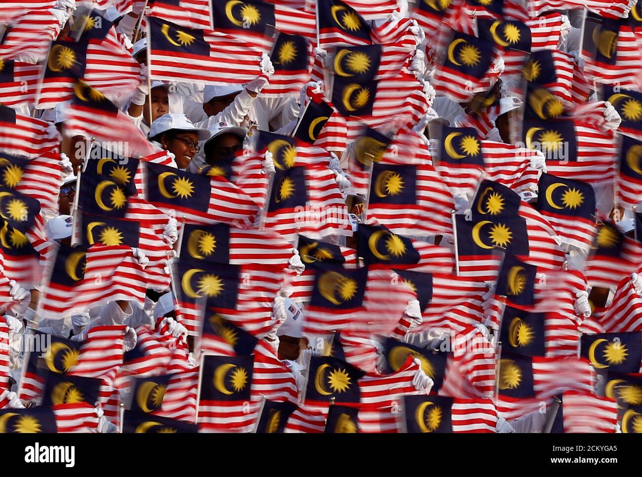 Performers hold up flags during the 62nd Merdeka Day (Independence 