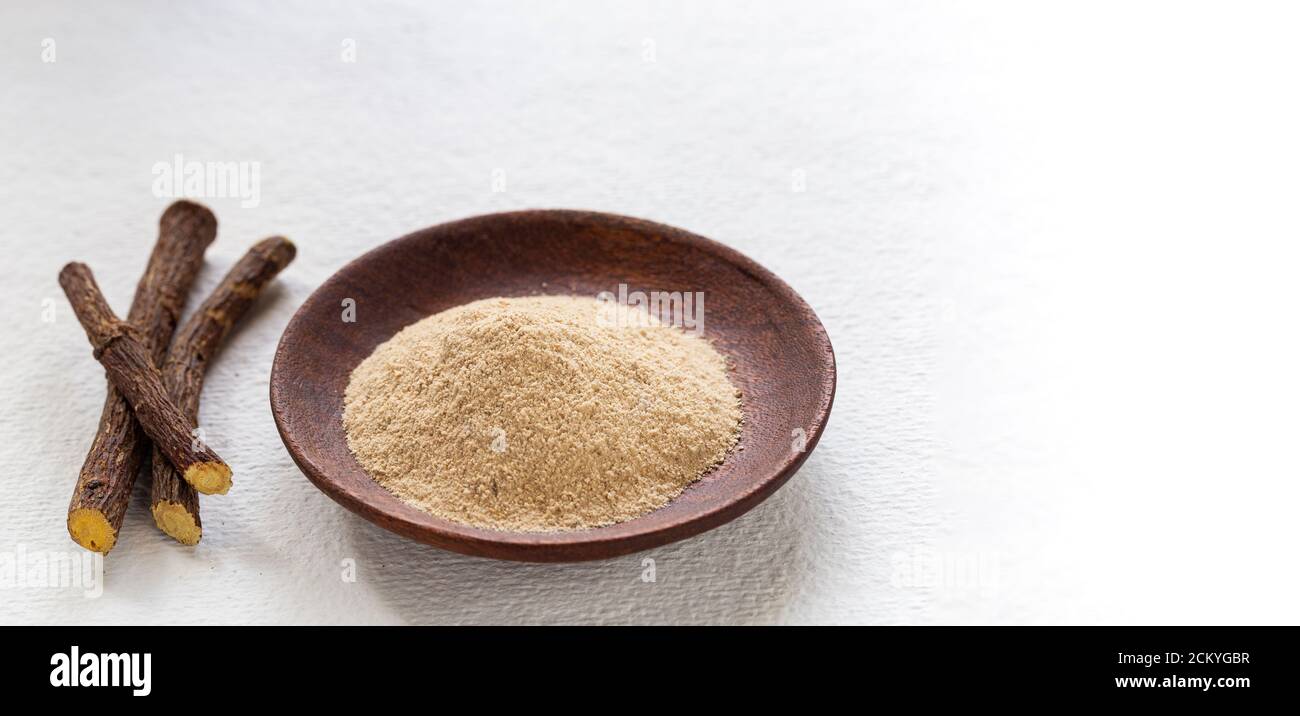 Licorice medicinal plant root, on white background Glycyrrhiza glabra