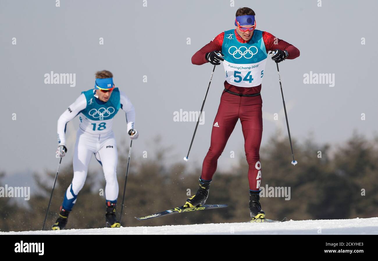 Cross-Country Skiing – Pyeongchang 2018 Winter Olympics – Men's 15km Free – Alpensia Cross-Country Skiing Centre – Pyeongchang, South Korea – February 16, 2018 - Andrey Larkov, an Olympic athlete from Russia, and Anssi Pentsinen of Finland compete. REUTERS/Murad Sezer Stock Photo