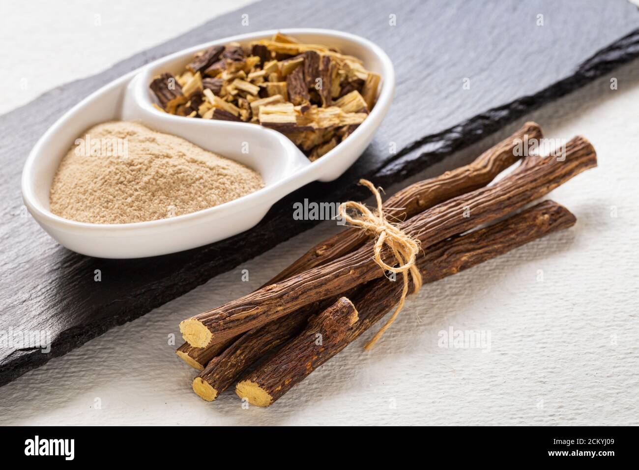 Licorice medicinal plant root, on white background Glycyrrhiza glabra