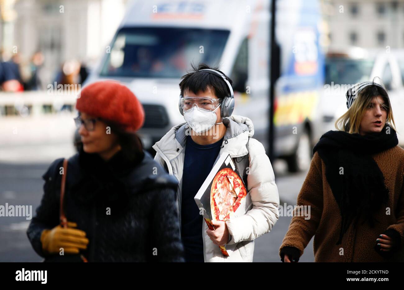 People are pictured wearing protective face masks in London, Britain