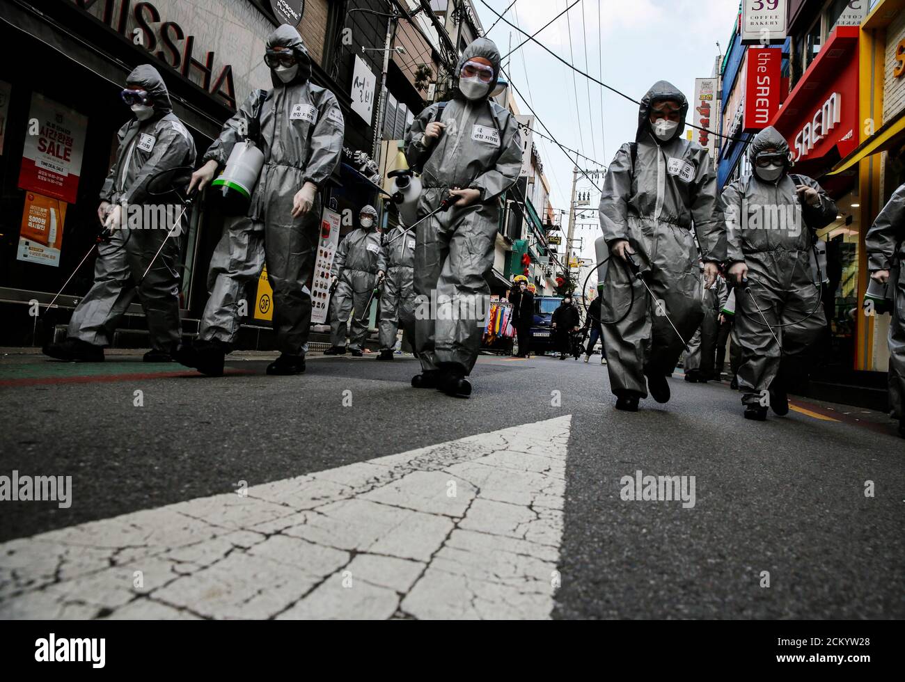 South Korean soldiers in protective gear sanitize a shopping street in Seoul, South Korea, March 4, 2020.    REUTERS/Heo Ran     TPX IMAGES OF THE DAY Stock Photo