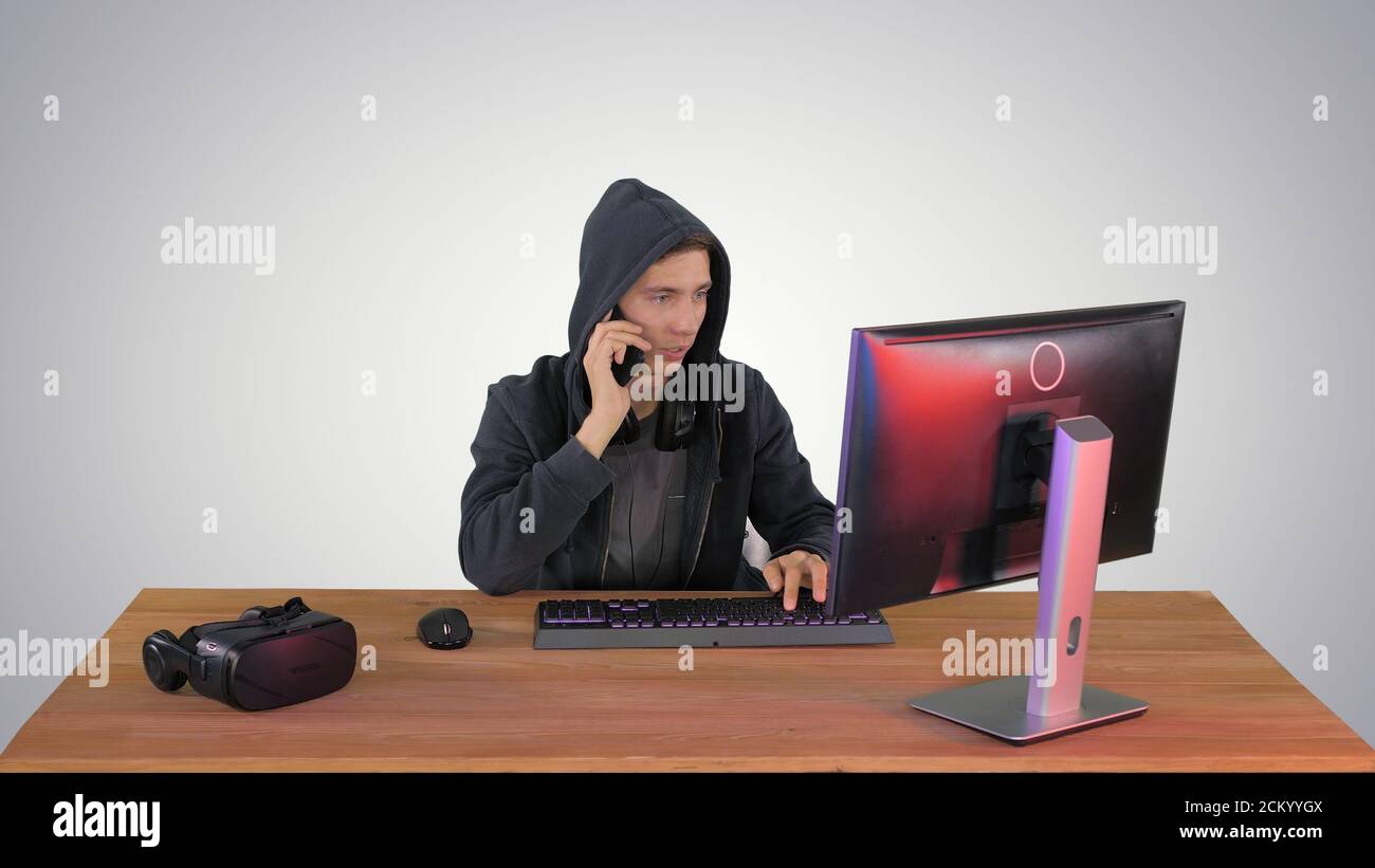 Experienced hacker answers someones call on gradient background. Stock Photo