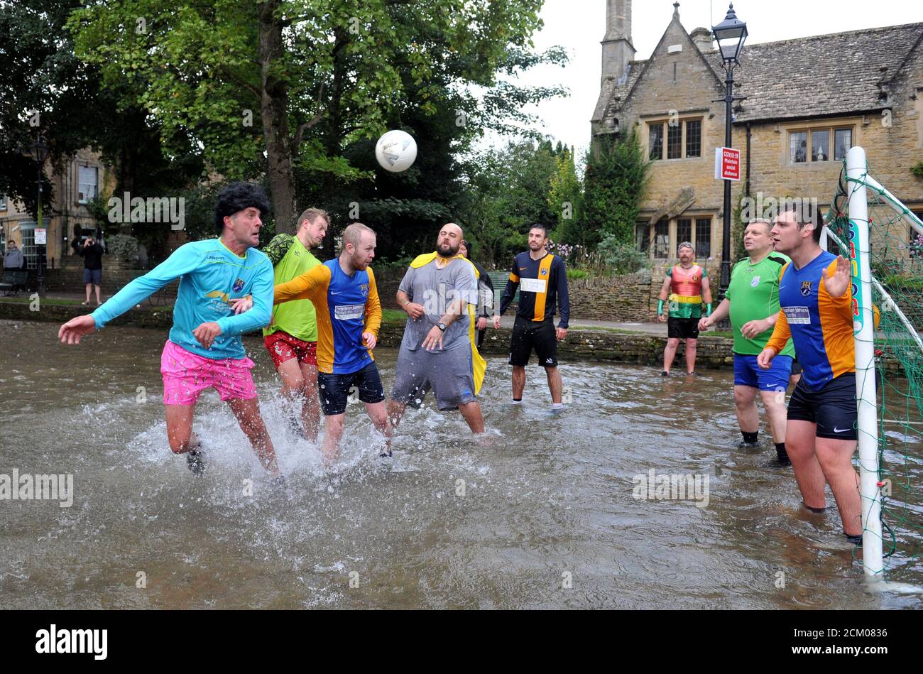 The annual football in the river match at Bourton-on-the-Water popular with tourist was played secretively so not to attract a crowd due to covid Stock Photo