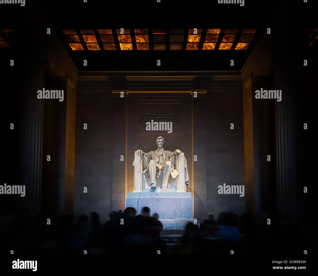 Inside the Lincoln Memorial in Washington, DC with tourists gathering. Stock Photo