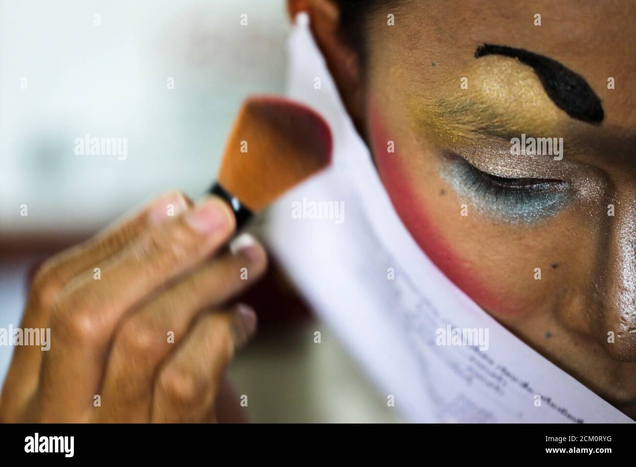 REFILE - CORRECTING TYPO IN NAME Teeraphong Meesat, 29, known as teacher  Bally applies make up before his English class at the Prasartratprachakit  School in Ratchaburi Province, Thailand, July 10, 2019. Picture