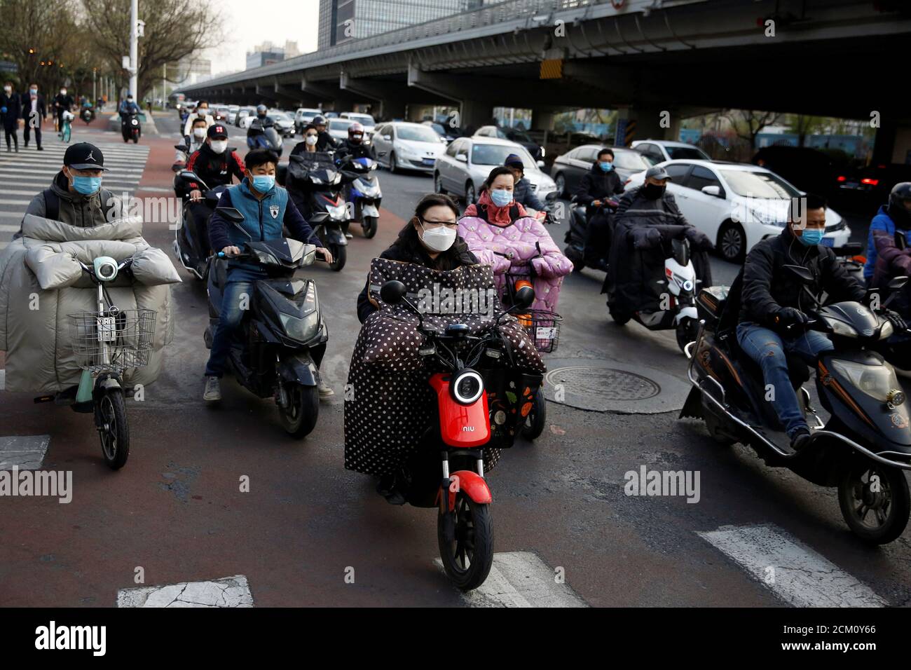 People wearing face masks are seen at Beijing's Financial Street during evening rush hour, as the country is hit by an outbreak of the novel coronavirus disease (COVID-19), China April 8, 2020. REUTERS/Tingshu Wang Stock Photo