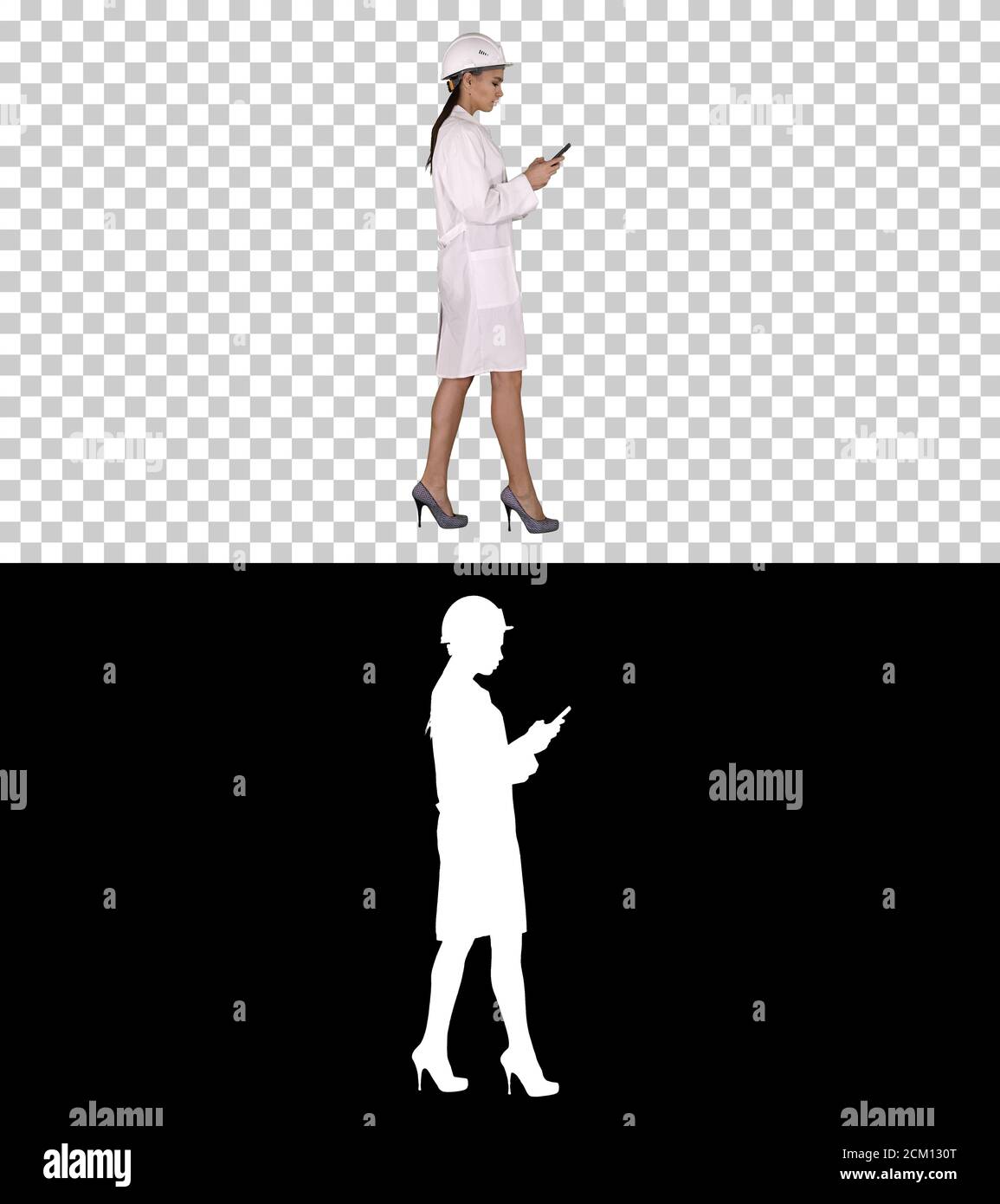 Engineer using mobile phone texting while walking, Alpha Channel Stock Photo