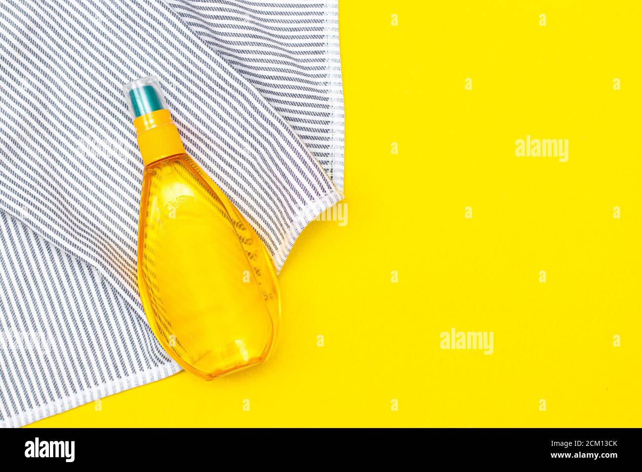 Tanning oil on a yellow background. Smooth tan. Perfect body. The beauty . Sun protection. Beach rest. Article about means for suntan. Summer vacation Stock Photo