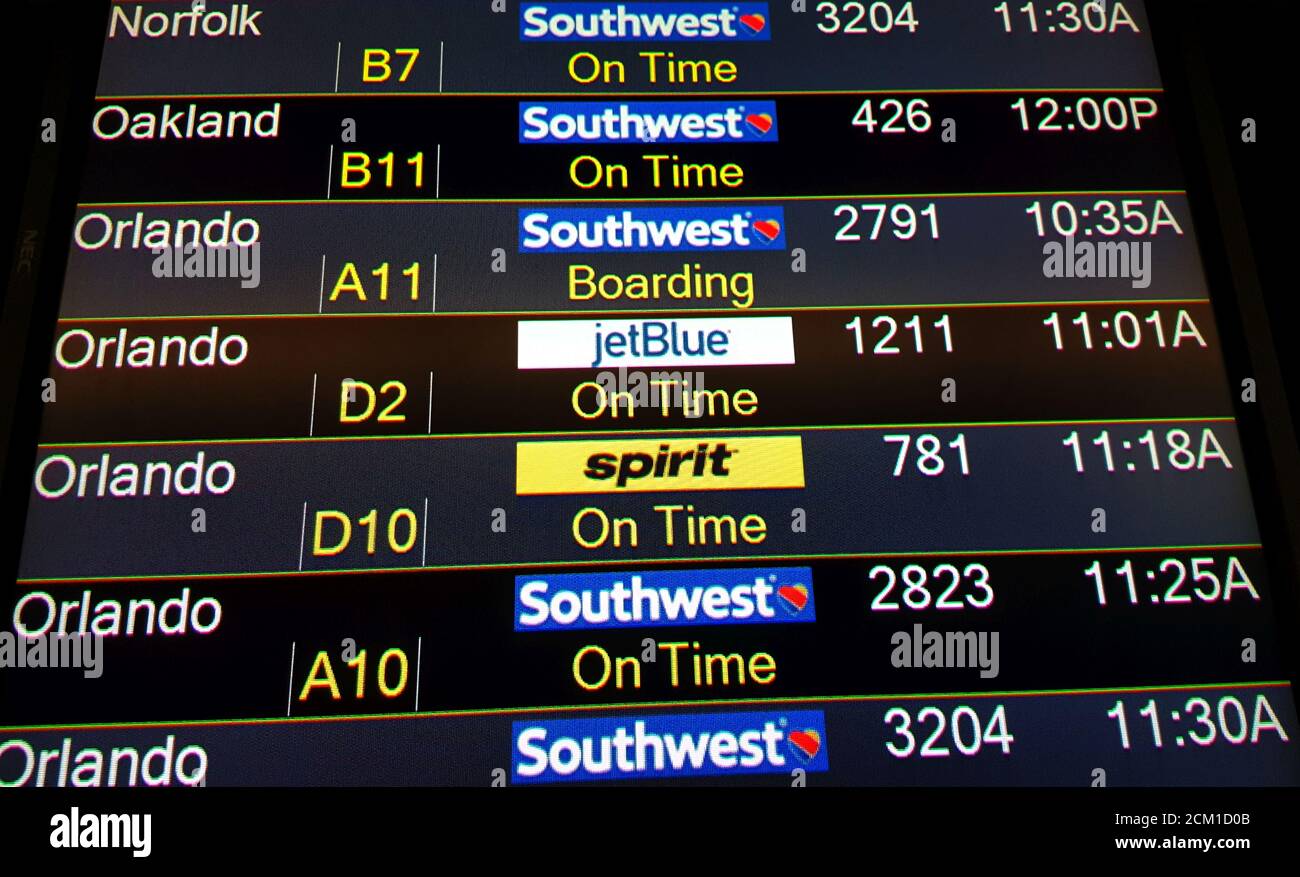 Flight departure board at Orlando International Airport, Orlando, Florida, United States Stock Photo