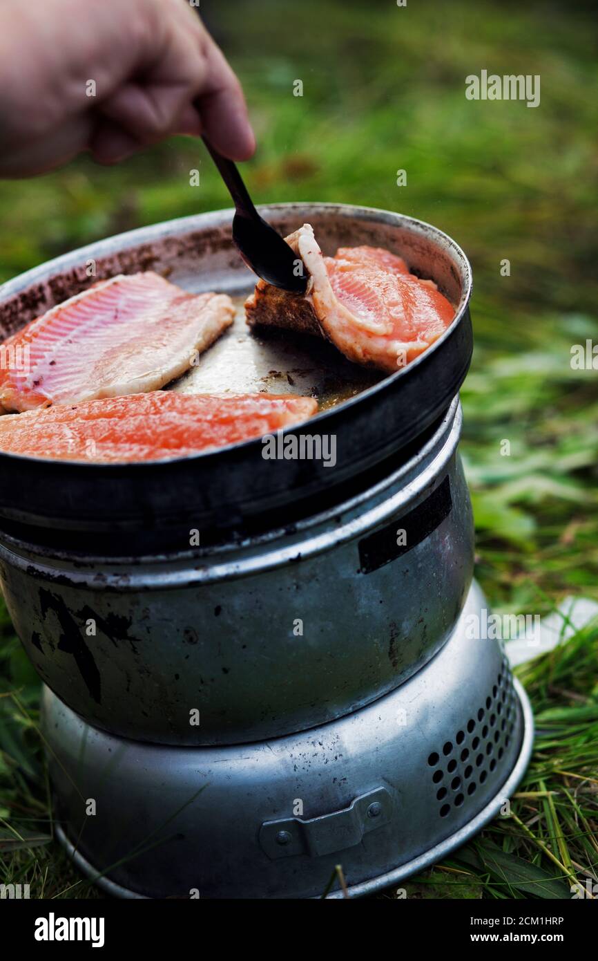 Frying freshly caught fish outdoors Stock Photo Alamy