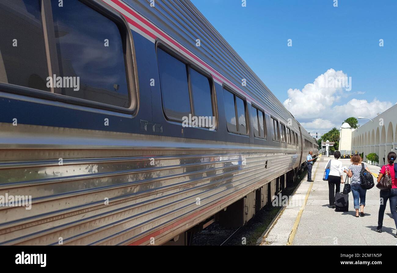 Train travelers depart a train at Orlando Health/Amtrak Train Station, also known as Orlando Station in Orlando, Florida, United States Stock Photo