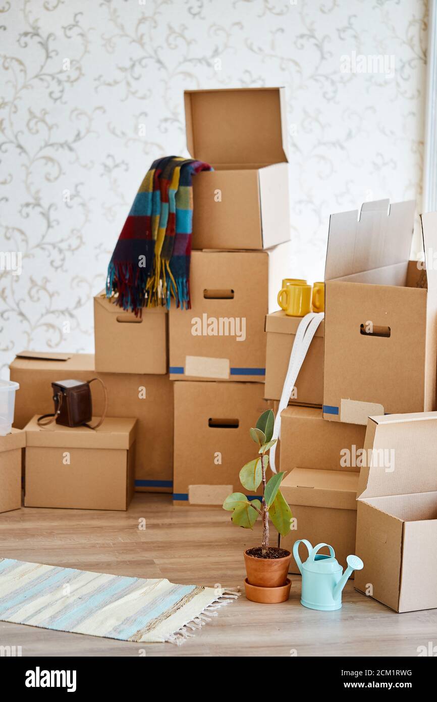 stack of boxes opened after moving in room Stock Photo Alamy
