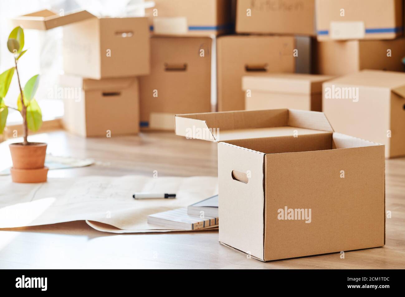 stack of boxes opened after moving in room Stock Photo - Alamy