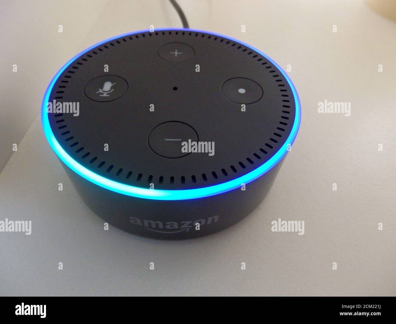 An Amazon Echo Dot is activated due to a voice command Stock Photo - Alamy