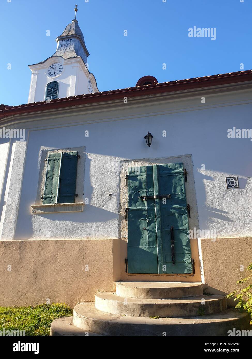 Closed metallic window shutters and gate in Rimetea, Romania. Architecture detail of unitarian church in the village of Rimetea, Torocko, Alba, Romani Stock Photo