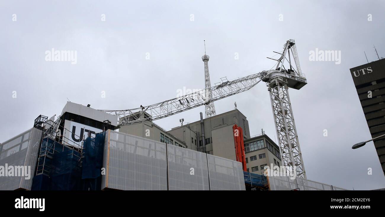 The collapsed hoisting jib of a tower crane lies on the building below at a construction site at University of Technology Sydney (UTS), in central Sydney November 27, 2012. Emergency services closed surrounding streets after the crane caught fire.  REUTERS/Tim Wimborne (AUSTRALIA - Tags: DISASTER BUSINESS INDUSTRIAL) Stock Photo