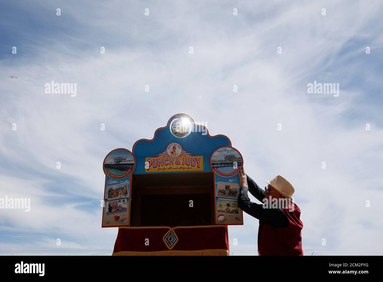 Punch and Judy "professor" Glyn Edwards prepares his booth before a