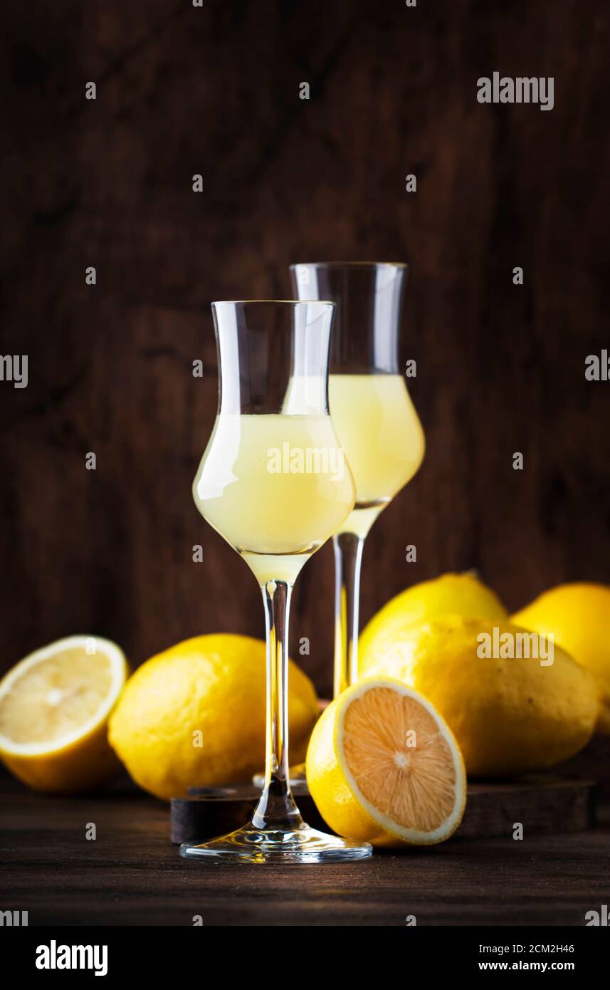 Limoncello, sweet Italian lemon liqueur, traditional strong alcoholic drink. Still life in vintage style, selective focus Stock Photo