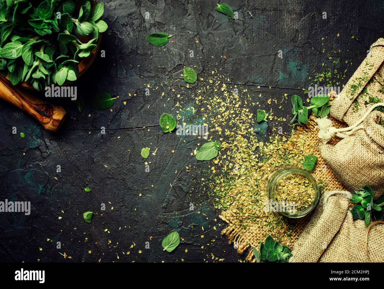 Dried ground oregano or marjoram, dark background, top view Stock Photo