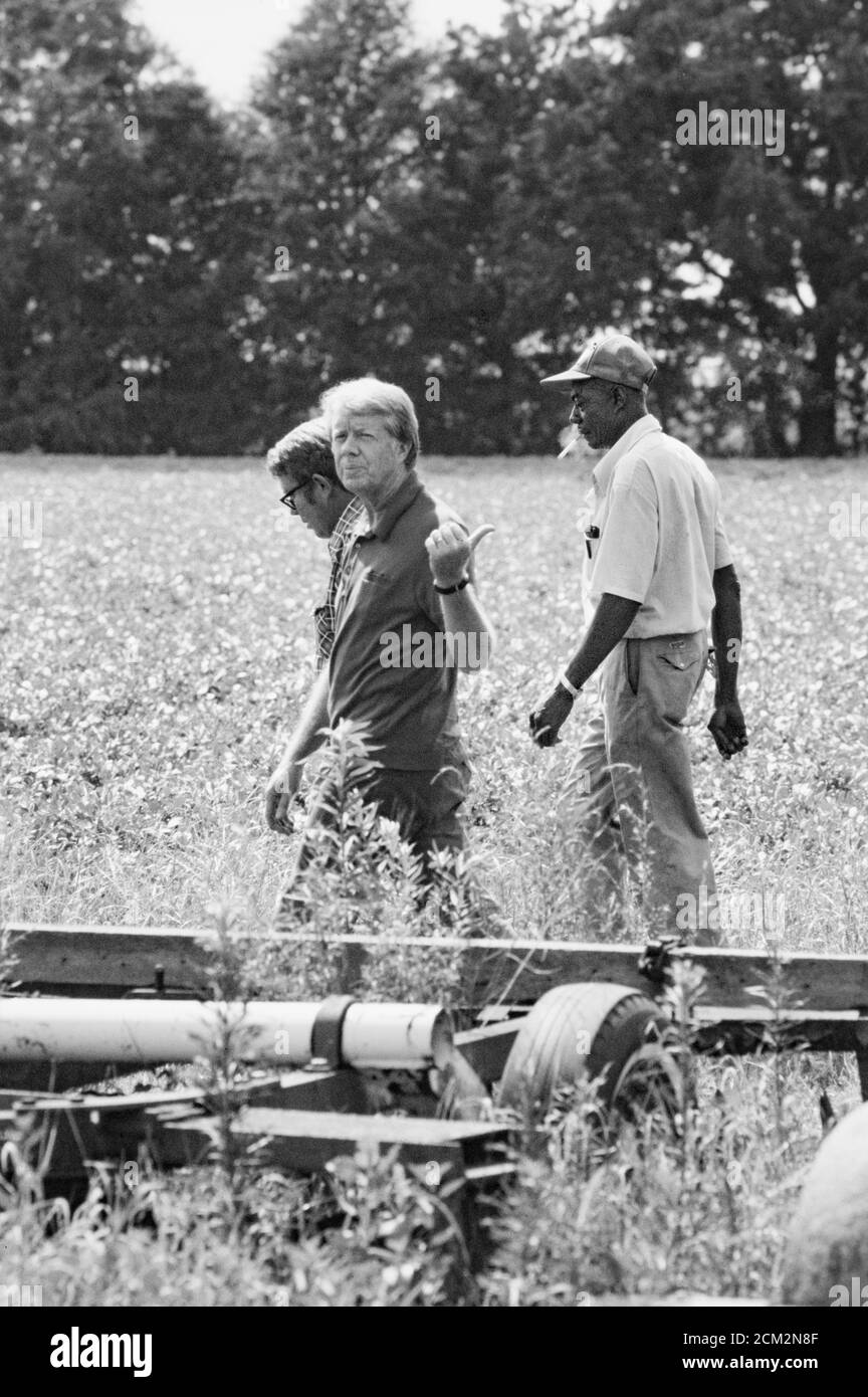 President Jimmy Carter, his brother Billy Carter and the Carter's tenant  farmer Leonard Wright survey the Carter peanut farm land during the  President's first trip back to his hometown of Plains, Georgia