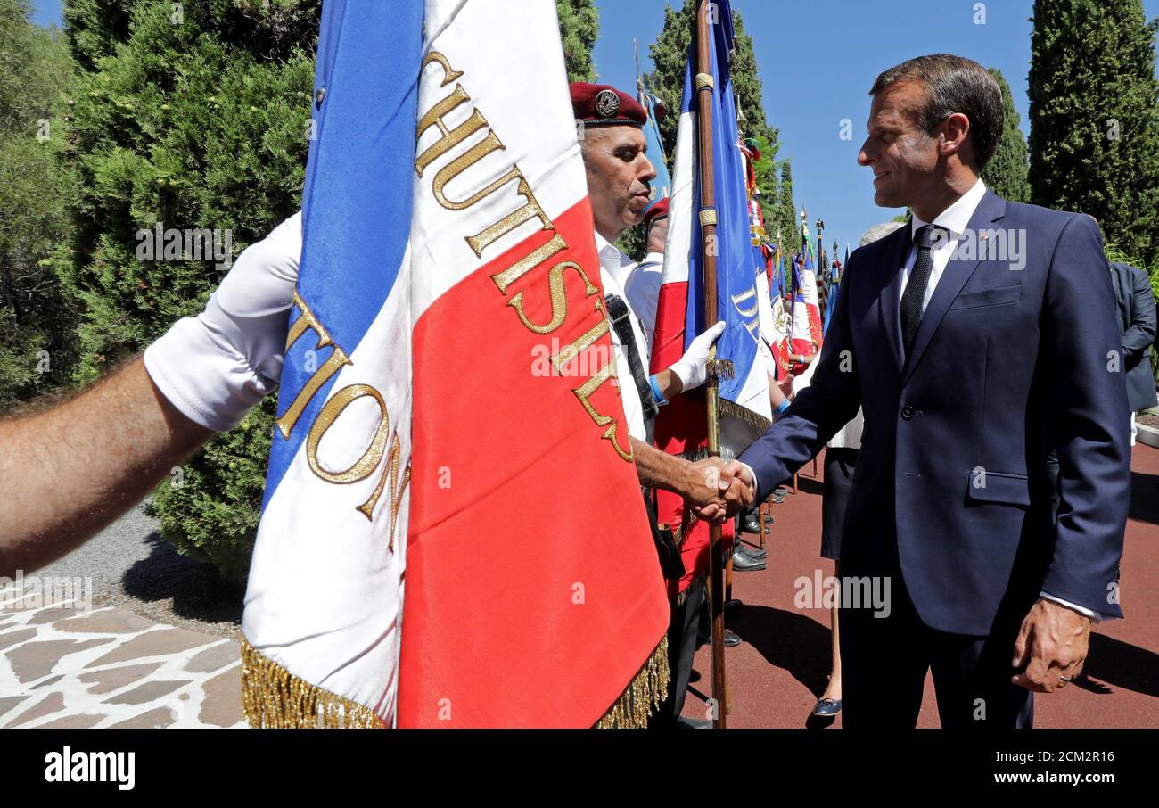 French President Emmanuel Macron shakes hands with a member of the Souvenir Francais during a ceremony marking the 75th anniversary of the Allied landings in Provence in World War Two which helped liberate southern France, in Boulouris, France, August 15, 2019.  REUTERS/Eric Gaillard/Pool Stock Photo