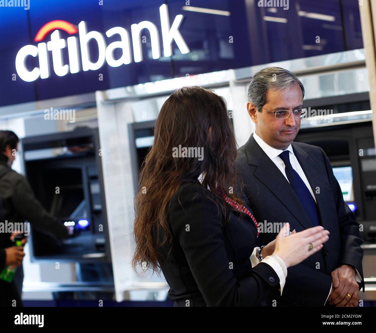 a-customer-service-representative-demonstrates-the-functions-of-an-interactive-sales-wall-to-vikram-pandit-chief-executive-officer-of-citi-during-the-opening-of-citi-s-new-flagship-branch-at-union-square-in