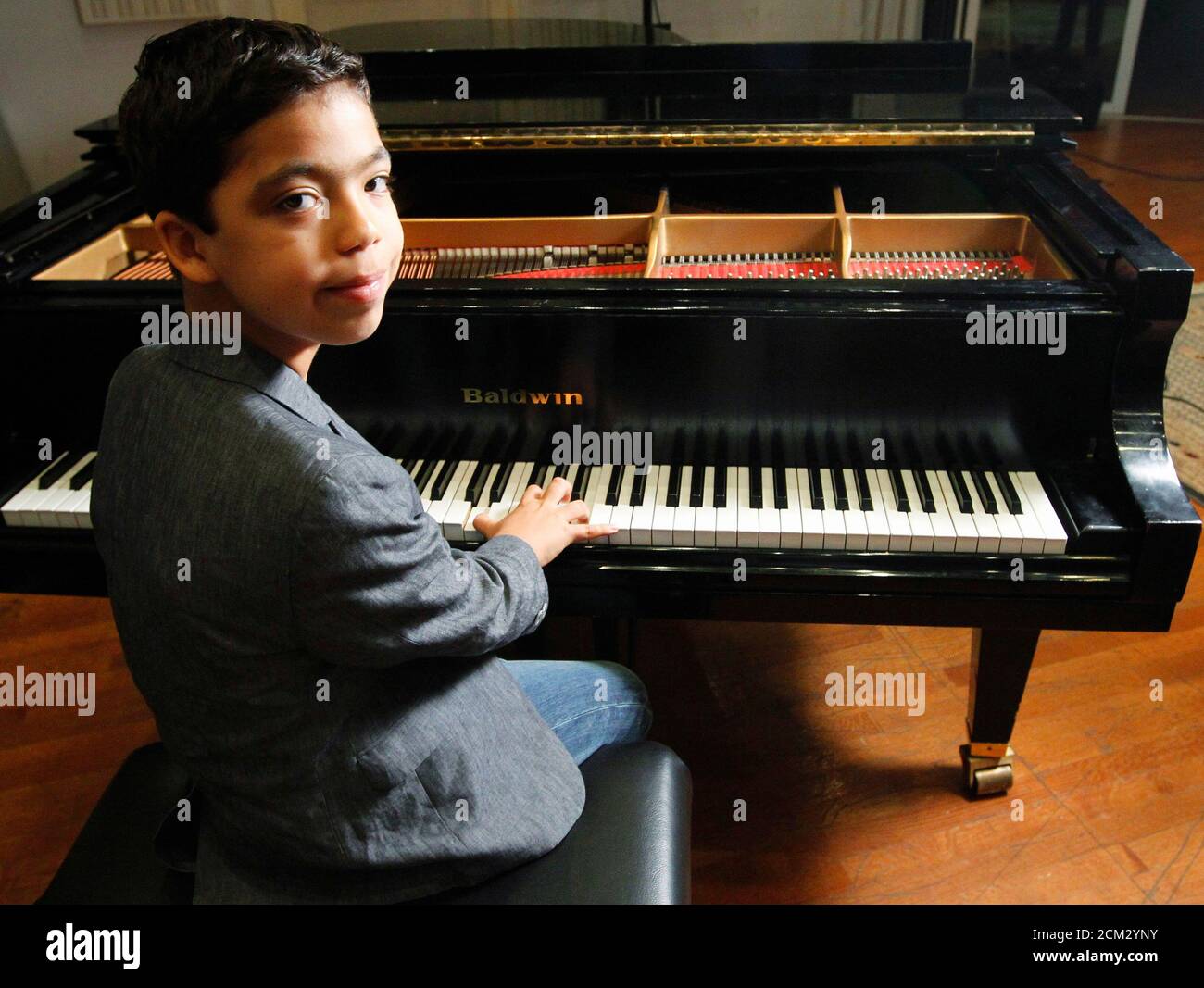 Eleven-year-old piano player, Ethan Bortnick, poses in a New York Studio,  July 25, 2012. Bortnick, was recognised as the youngest solo musician to  headline his own tour by the Guinness Book of