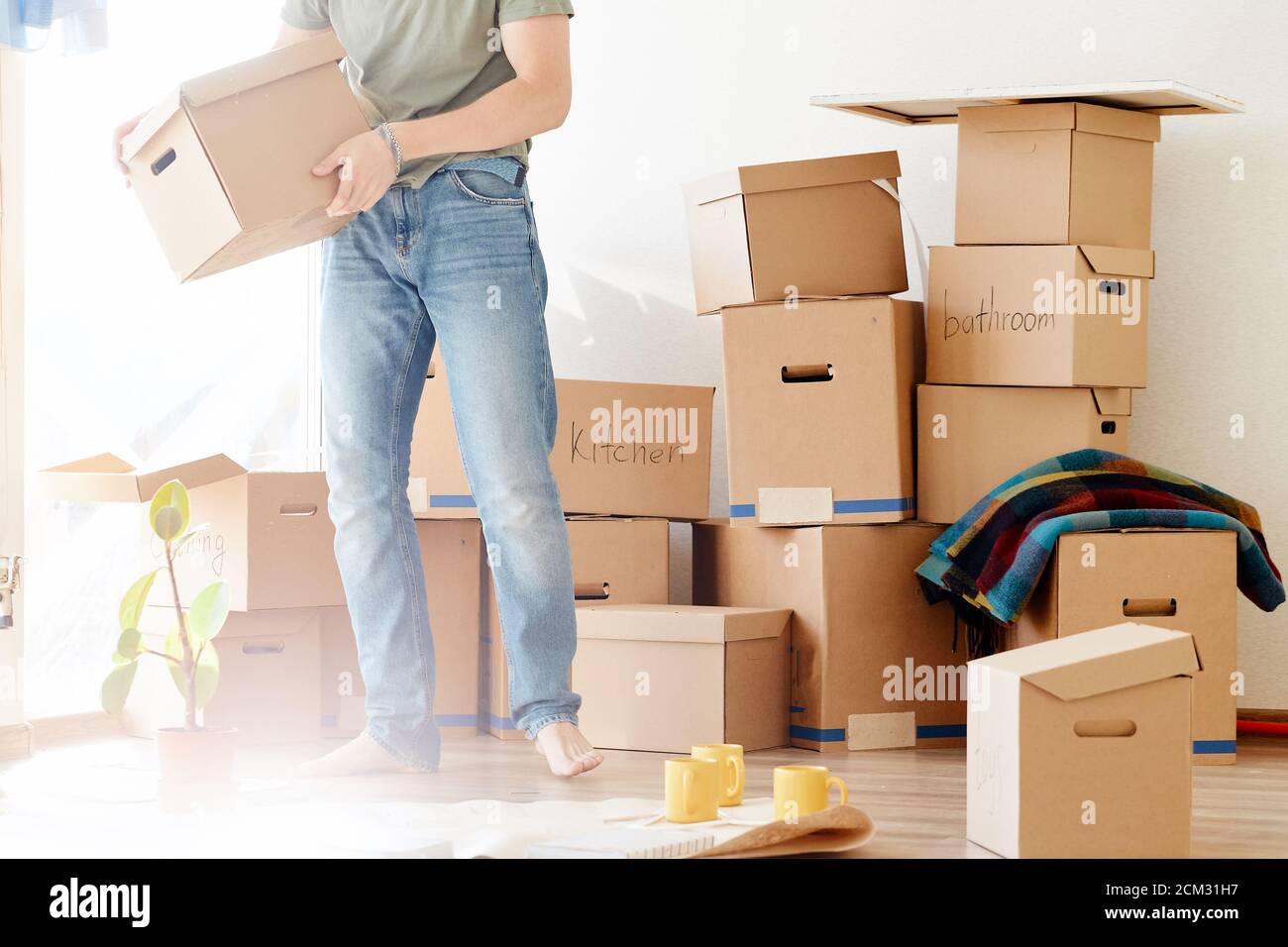 Smiling man hold boxes in new home. Dreaming new home Stock Photo