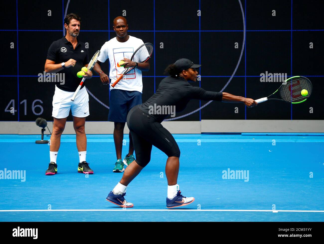 Serena Williams of the U.S. is watched by her coaching staff as she hits a  shot during a training session ahead of the Australian Open tennis  tournament in Melbourne, Australia, January 11,