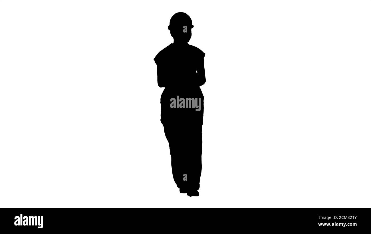 Silhouette Female constuction worker counting money while walkin Stock Photo
