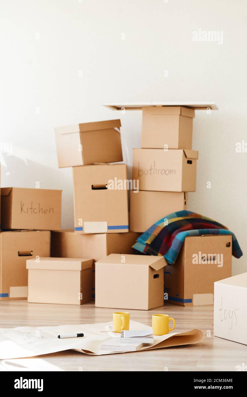 stack of boxes opened after moving in room Stock Photo Alamy