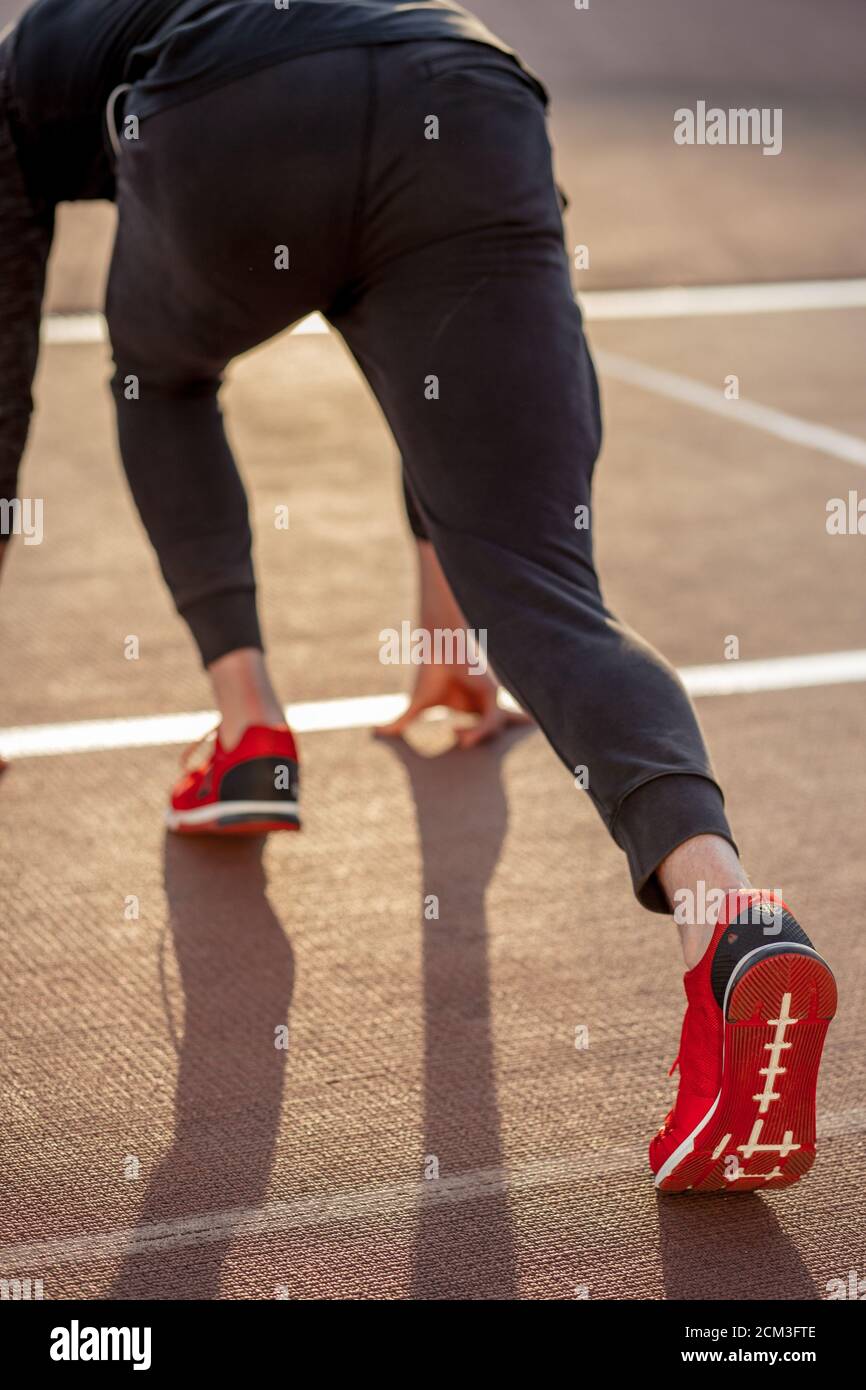 Back view of man feet in starting position for running on race track in stadium Stock Photo Alamy