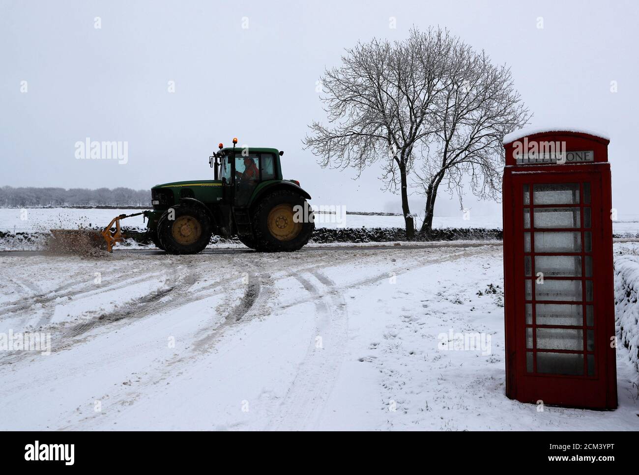 A tractor with a snow plough clears the A515 near Buxton, Britain December 29, 2017. REUTERS/Darren Staples Stock Photo