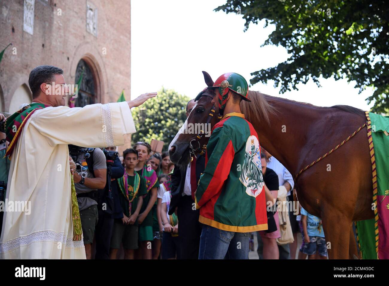 The horse 'Remorex' and its jockey Federico Arri, also known as 'Ares',  from La Contrada del Drago, get a blessing from priest Alfredo Scarciglia  before the traditional annual horse race Palio di