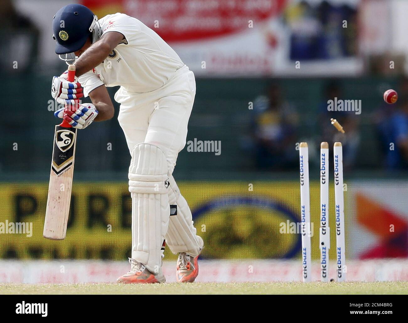 India's Cheteshwar Pujara is bowled out by Sri Lanka's Dhammika Prasad during the third day of their third and final test cricket match in Colombo August 30, 2015. REUTERS/Dinuka Liyanawatte Stock Photo