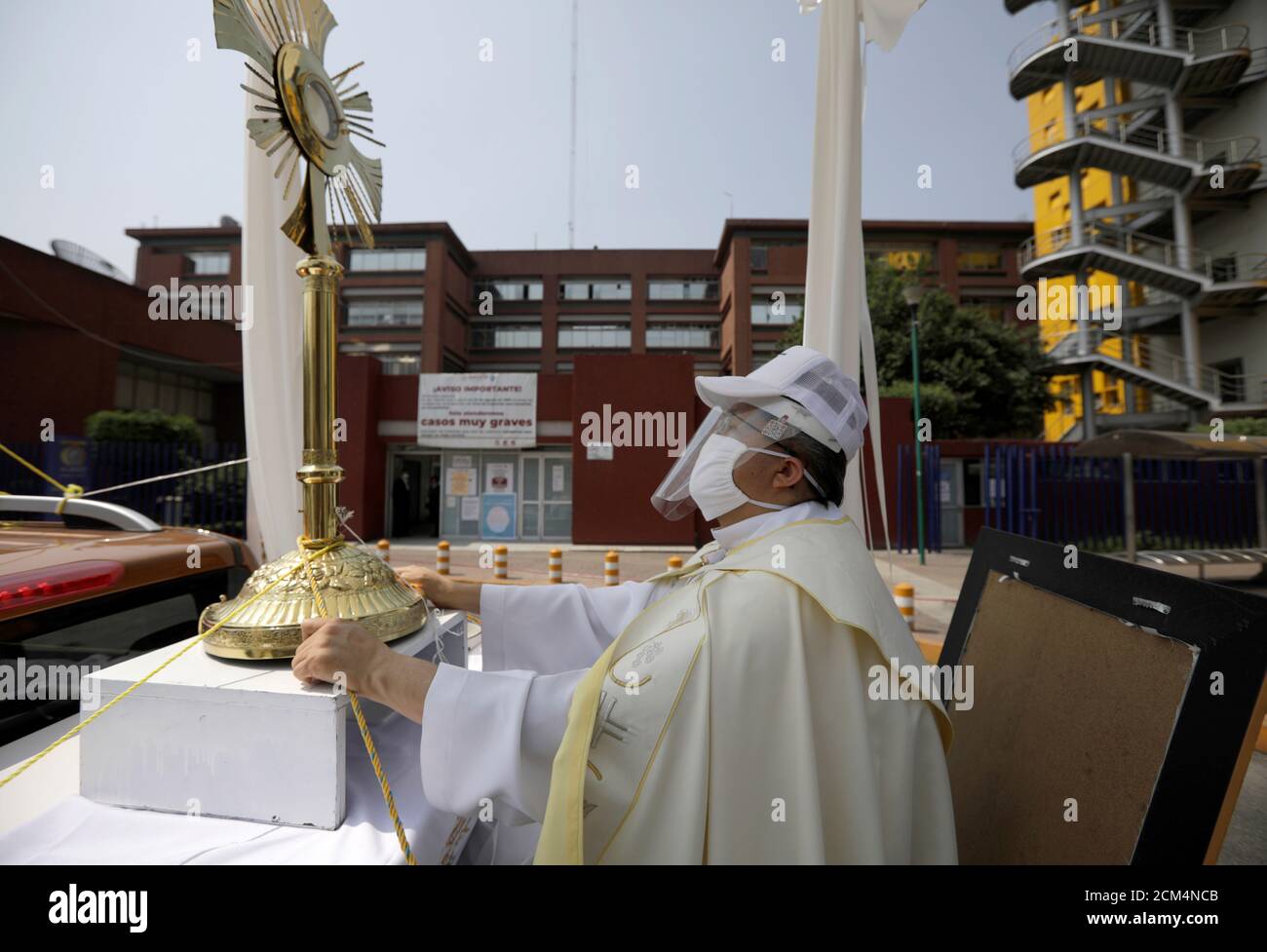 Angel Lauro Sanchez, the parish priest of the Catholic Church of the Lady of the Rosary, performs a procession in the streets with the image of the Sacrament Jesus to pray for soon dissipation of the current situation coronavirus disease (COVID 19) pandemic, in Mexico City, Mexico April 19, 2020. REUTERS/Luis Cortes Stock Photo
