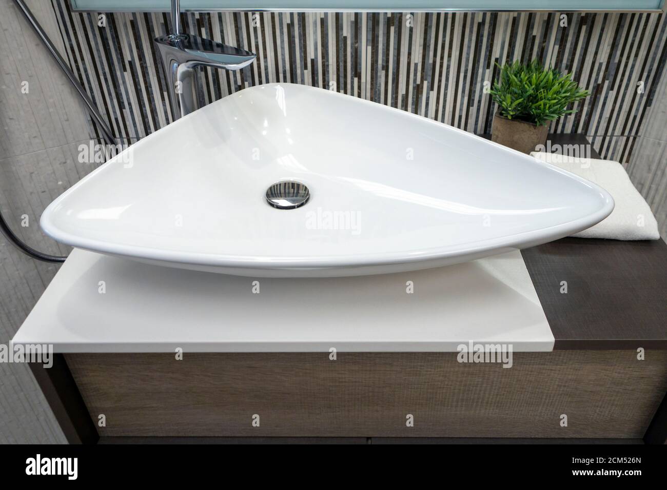 Basin Ceramic Triangle Hardware Plumbing Fixtures Bathroom Sinks with  chrome fixtures and plant Stock Photo - Alamy