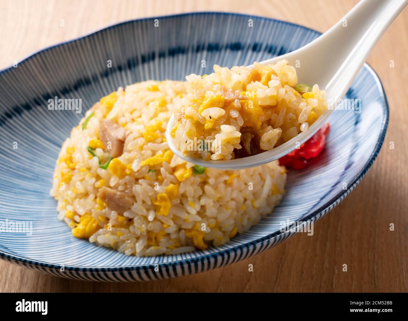 Scoop the fried rice with a Chinese soup spoon Stock Photo Alamy
