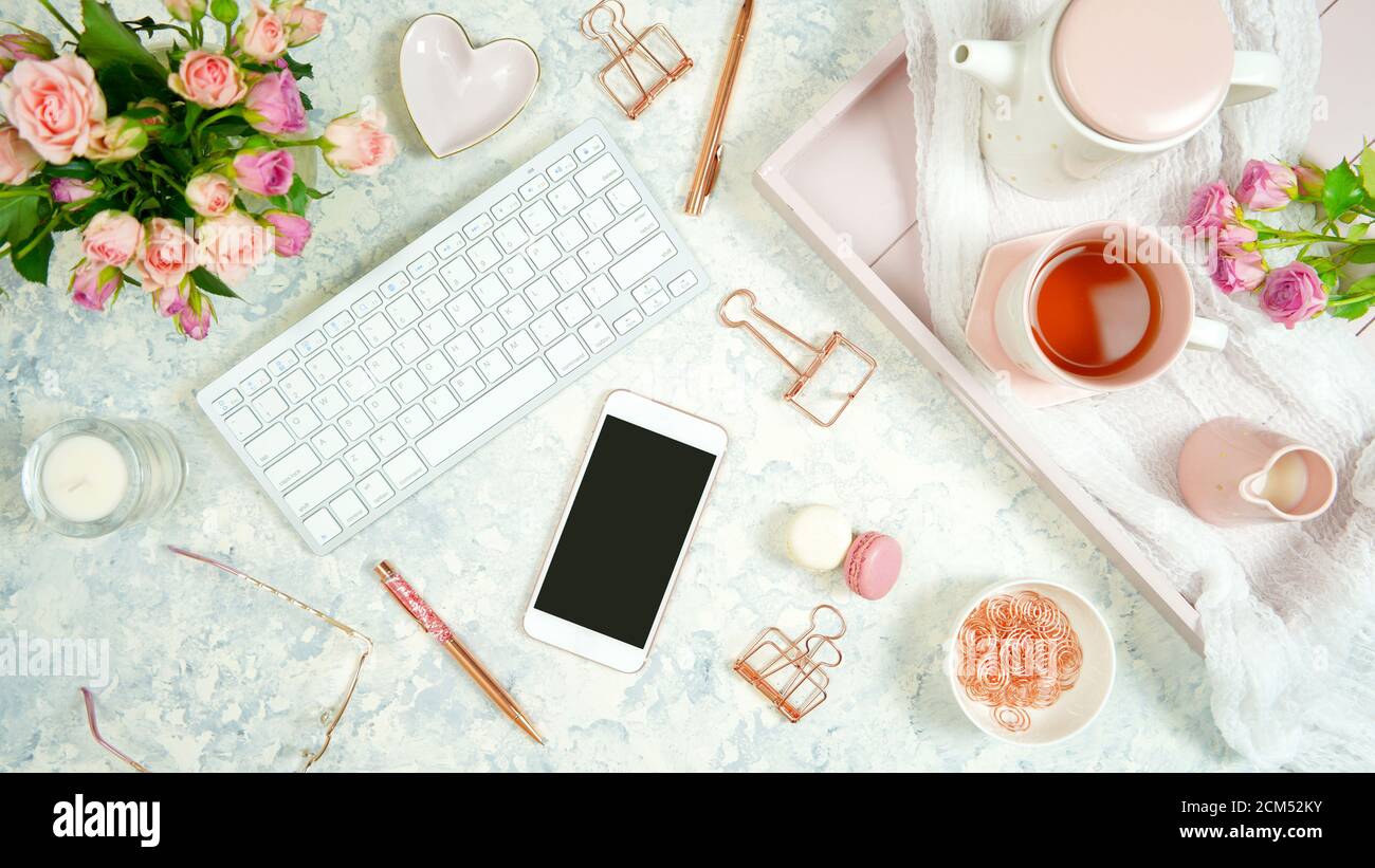Blush pink theme cosy hygge desktop workspace with keyboard smart phone ...