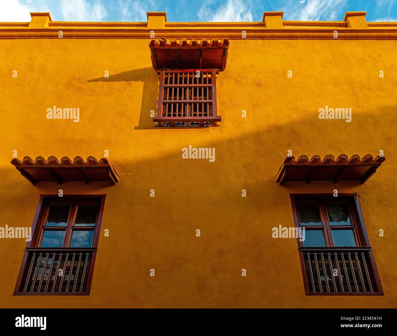 Orange facade with windows in colonial style, Cartagena, Colombia. Stock Photo