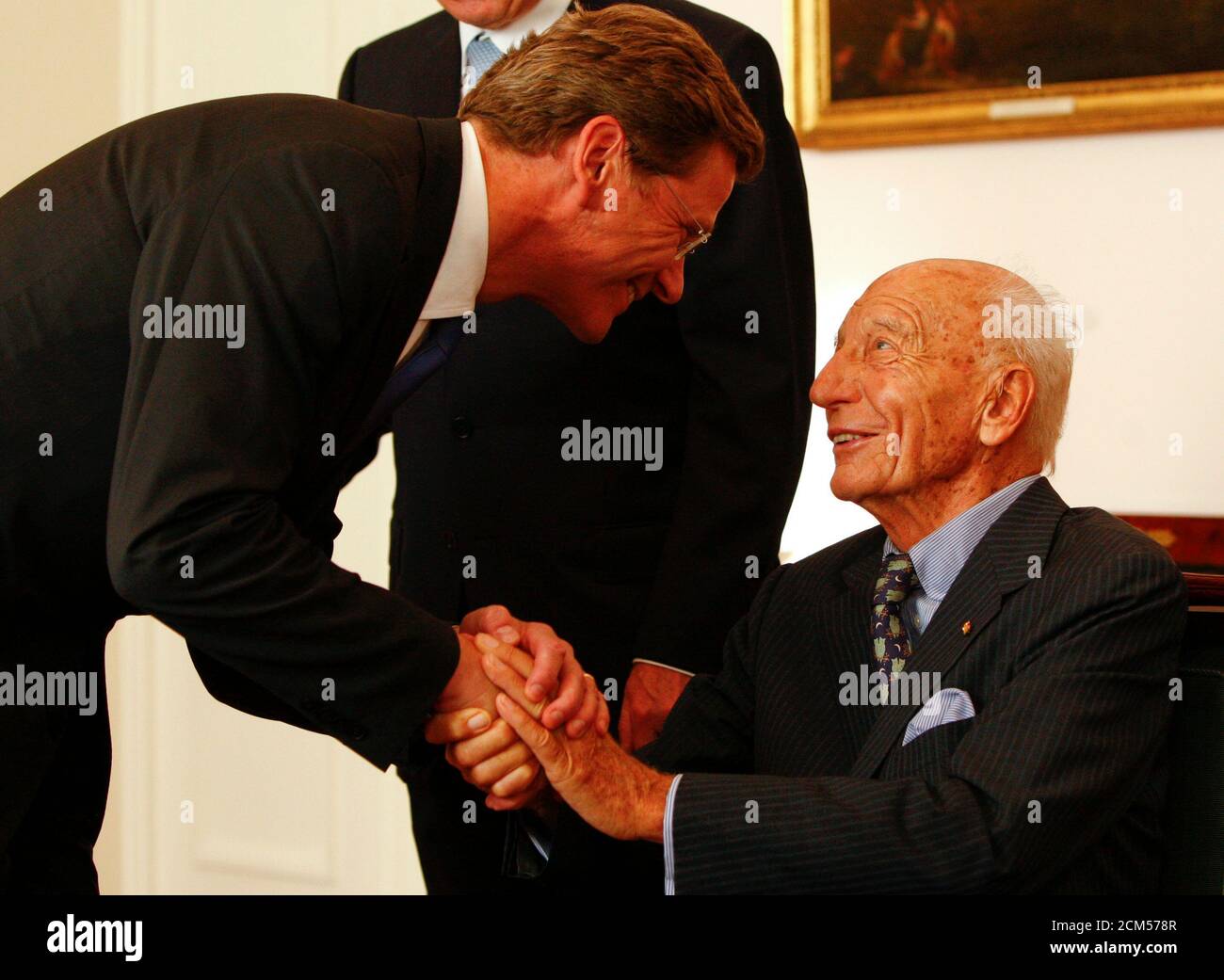 The leader of Germany's FDP liberal party Guido Westerwelle (L) congratulates former German President Walter Scheel on his 90th birthday in the Bellevue Palace in Berlin July 15, 2009. Germany's current President Horst Koehler is pictured in the background.    REUTERS/Thomas Peter   (GERMANY) Stock Photo