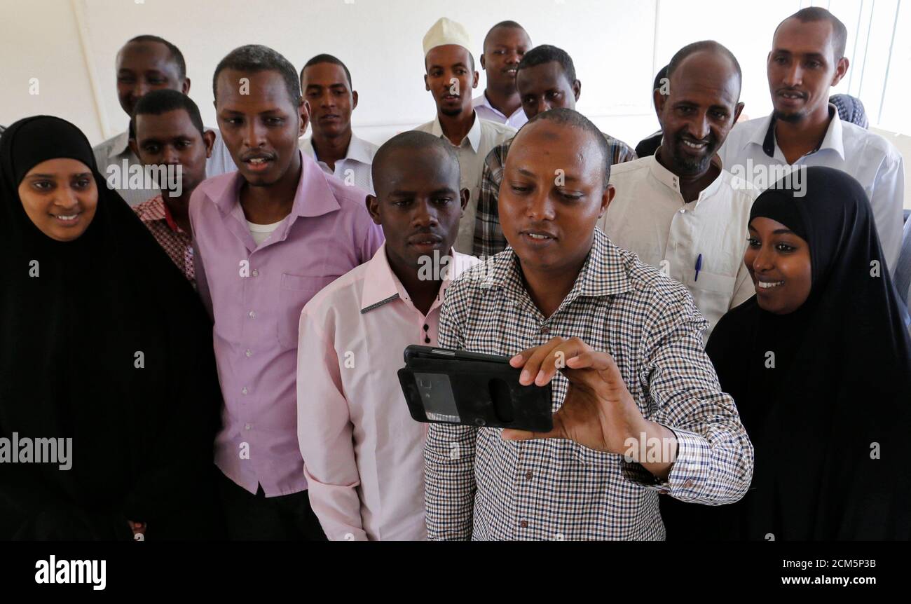 Students who survived the Garissa University College attack take a group selfie photograph as they return to the campus in Kenya's northeast town of Garissa, January 11, 2016. The campus reopened today nine months after an attack by Somalia-based al-Qaeda linked al-Shabaab Islamist militants. REUTERS/Thomas Mukoya      TPX IMAGES OF THE DAY Stock Photo
