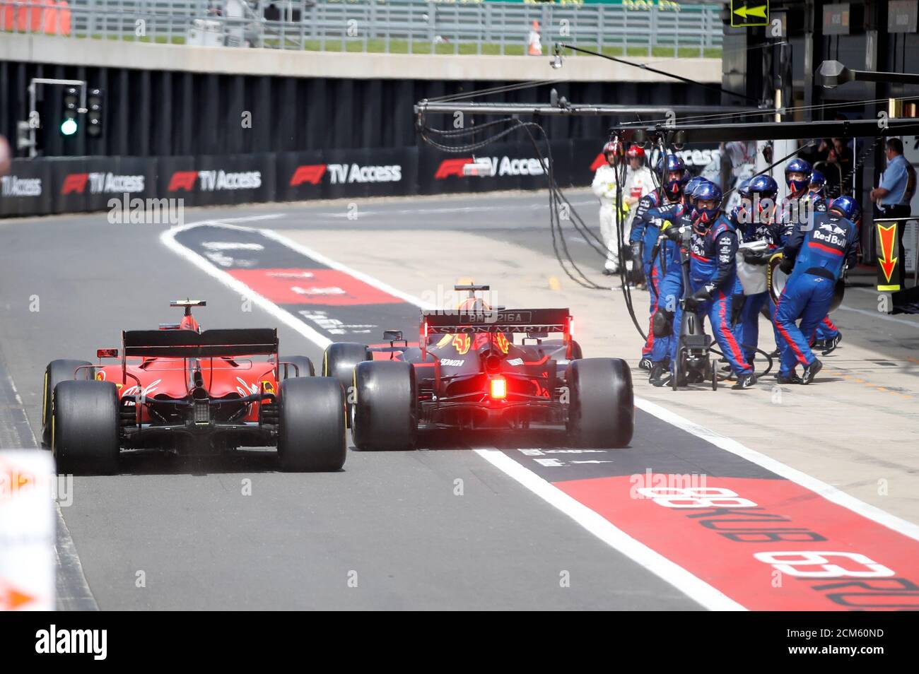 Formula One F1 - British Grand Prix - Silverstone Circuit, Silverstone,  Britain - July 14, 2019 Ferrari's Charles Leclerc and Red Bull's Max  Verstappen in action in the pit lane during the
