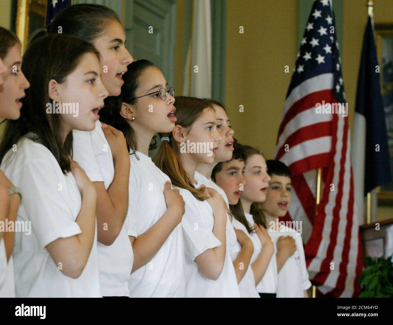 Schoolchildren from the French-American 'Ecole Bilingue/International School of Boston' sing the French and United States national anthems as they stand in front of the countries flags at ceremonies honoring the Marquis de Lafayette, a French General and politician who became a hero in the American revolutionary war, inside the Massachusetts Statehouse in Boston, May 20, 2003. French and local officials joined together on the 169th anniversary of Lafayette's death to reassert the common democratic values of the two countries despite recent diplomatic and military policy differences. REUTERS/Ji Stock Photo