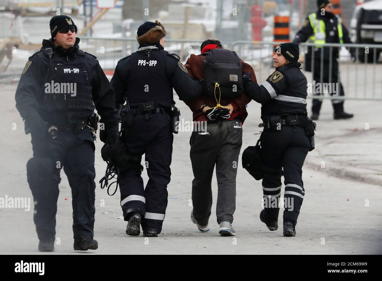 Police detain a counter-protester during a far-right rally against the U.N. migration pact on Parliament Hill in Ottawa, Ontario, Canada December 8, 2018. REUTERS/Chris Wattie Stock Photo