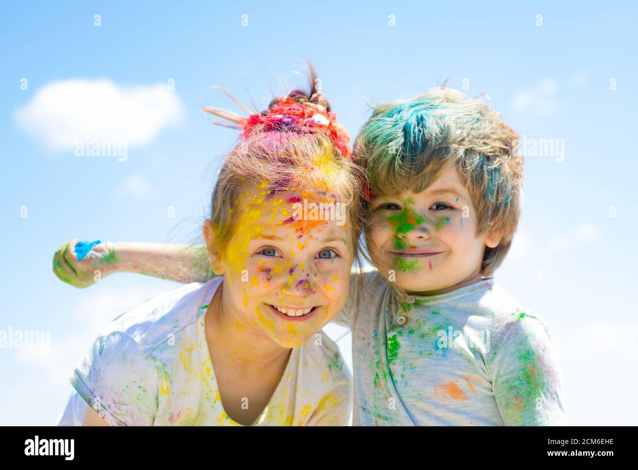 Two kids with face smeared with colors. Poor funny children playing holi  Stock Photo - Alamy