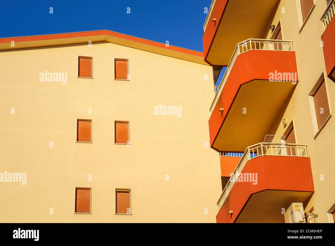 orange popular buildings with sky background Stock Photo - Alamy